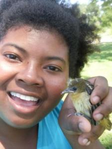 Danielle N. Lee, holding a goldfinch, is on a mission to spread science love.