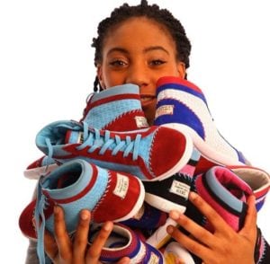 Little League star Mo'ne Davis with her new line of shoes, a portion of which will helps girls around the world. (Photo: M4D3 — Make A Difference Everyday) 