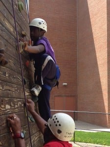 Damani, who has Down syndrome, is a typical kid in many respects. Here, he rock climbs with his father.