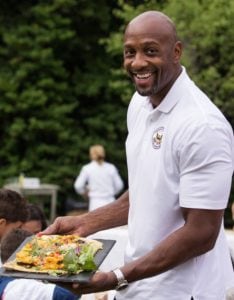 Alonzo Mourning, seven-time NBA All-Star and member of the President's Council on Fitness, Sports & Nutrition, holds up the Grilled Flatbread with Basil Puree and Garden Vegetables, prepared from Fall Garden Harvest of the First Lady's Kitchen Garden. (Photo: Cheriss May/HUNS)